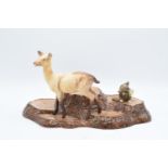 A collection of Beswick to include tree stump bird base, Doe 999A and Bush baby holding mirror