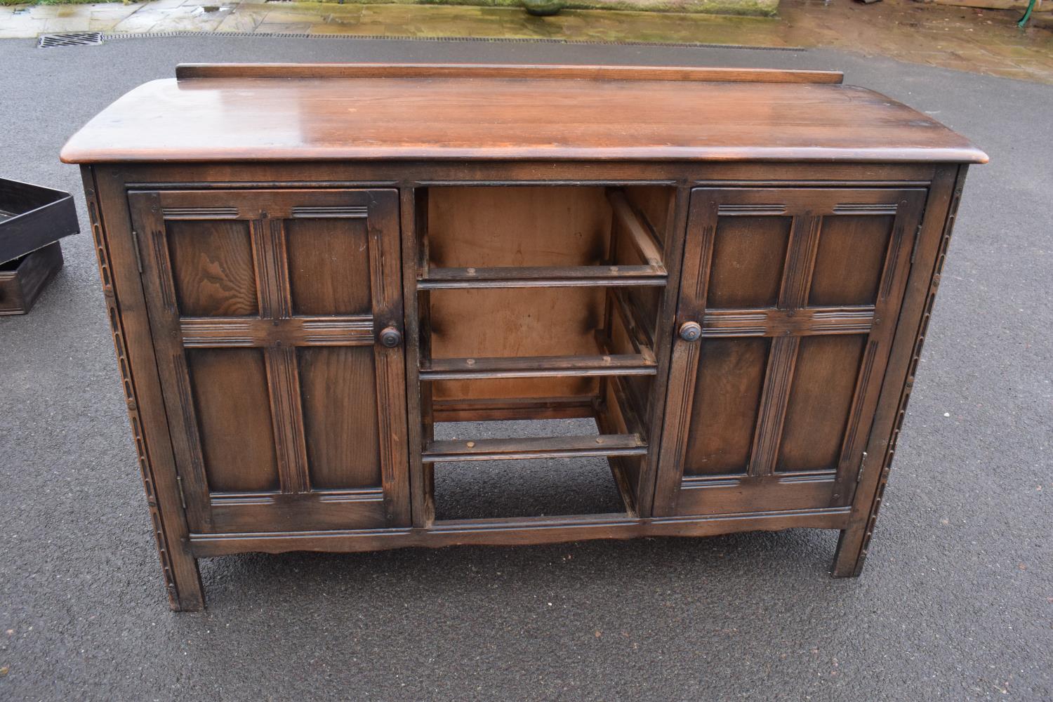 Ercol dark elm sideboard with 2 doors and 4 drawers. In good functional condition with some areas of - Image 2 of 9