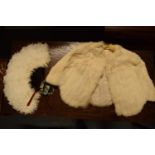 A ladies fur stole in original box with a feather fan. Box is very tatty and tired. In good