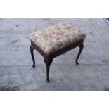 Early 20th century piano stool with cabriole legs and a lift up seat. In good condition with some