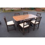 Ercol elm dining table together with 6 matching chairs in a colonial style. Generally in good