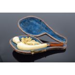 Cased meerschaum pipe with a turtle decoration. The mouth piece is a/f and there is damage to the