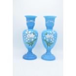 A pair of large blue painted glass vases with floral scenes. In good condition with no obvious