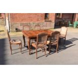 Edwardian extending table together with 6 wicker-style back dining chairs (7). The table is in