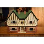 Large 20th century wooden dolls house with 6 rooms, opens from the back. With electrics which will