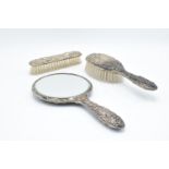 A silver dressing table set to include a mirror, brush and hair brush hallmarked for 1920, we
