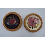 Moorcroft pin trays in the Pink Magnolia and Berries and Finch design both in a wooden wall