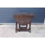 18th century thick oak drop-leaf gate leg table. 74cm tall.