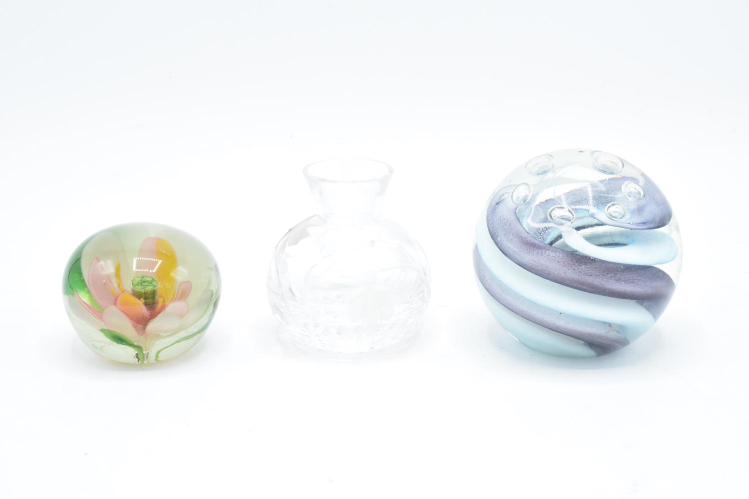 A boxed paperweight together with a smaller example and a Stuart Crystal miniature vase.