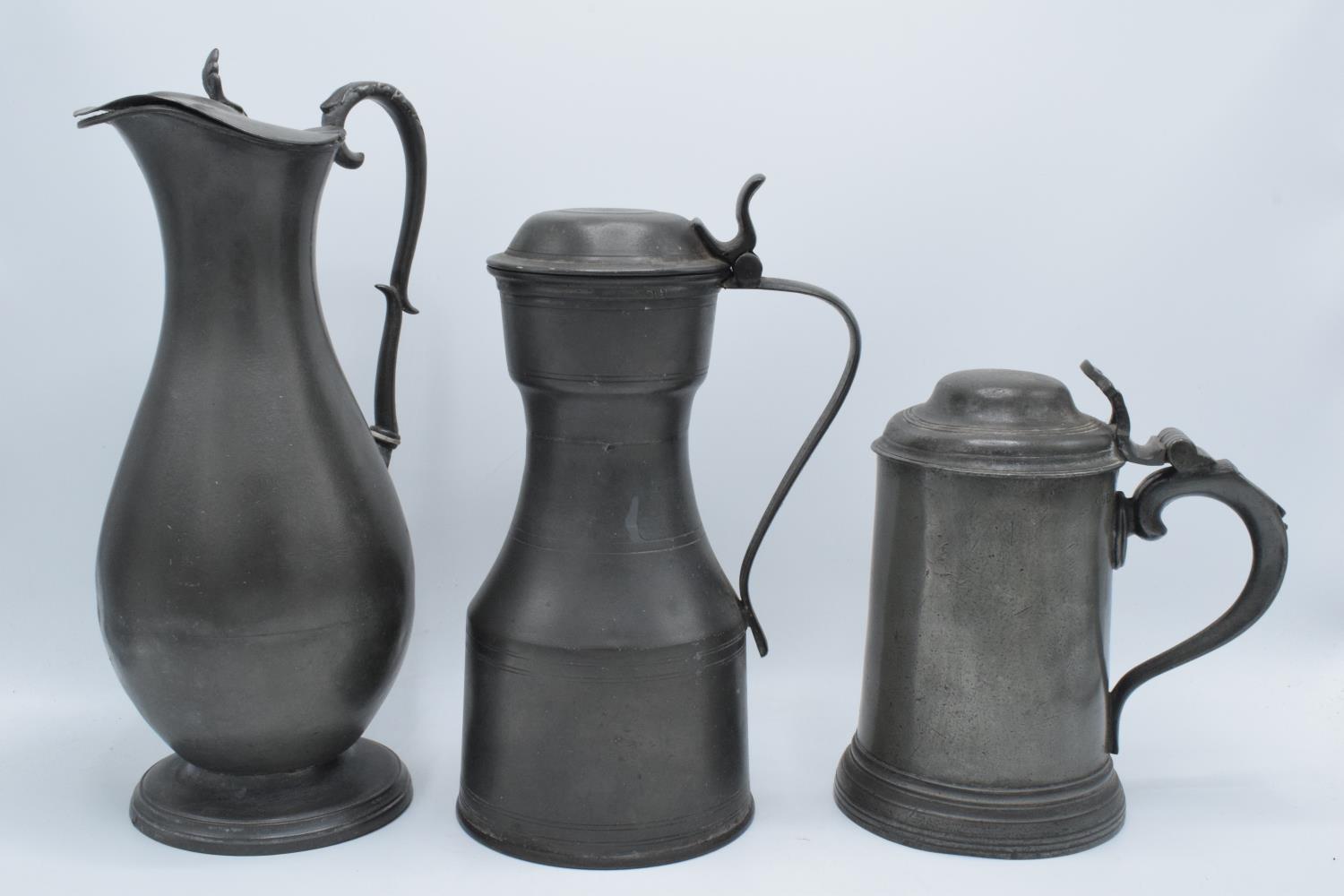 Early 19th century pewter to include a flagon, a jug and a lidded tankard (3) As expected. Flagon