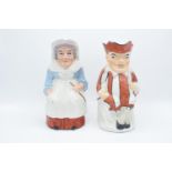 A pair of 19th century large Staffordshire Toby jugs to consist of Punch and Judy (2). Some paint