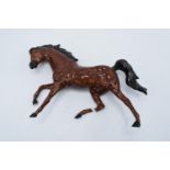 An interesting Royal Doulton model of a galloping horse in a brown colourway with a Royal Doulton