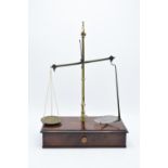 Early 20th century brass scales mounted a wooden base with a pull out. They display well. Might