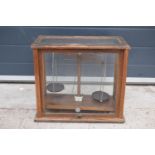 A early-mid 20 century wooden cased set of laboratory scales made WBN of Glasgow. Sold as decorative