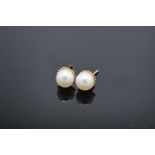 A pair of 9ct gold earrings with pearls. Gross weight 1.2 grams. Unmarked but test as 9ct.