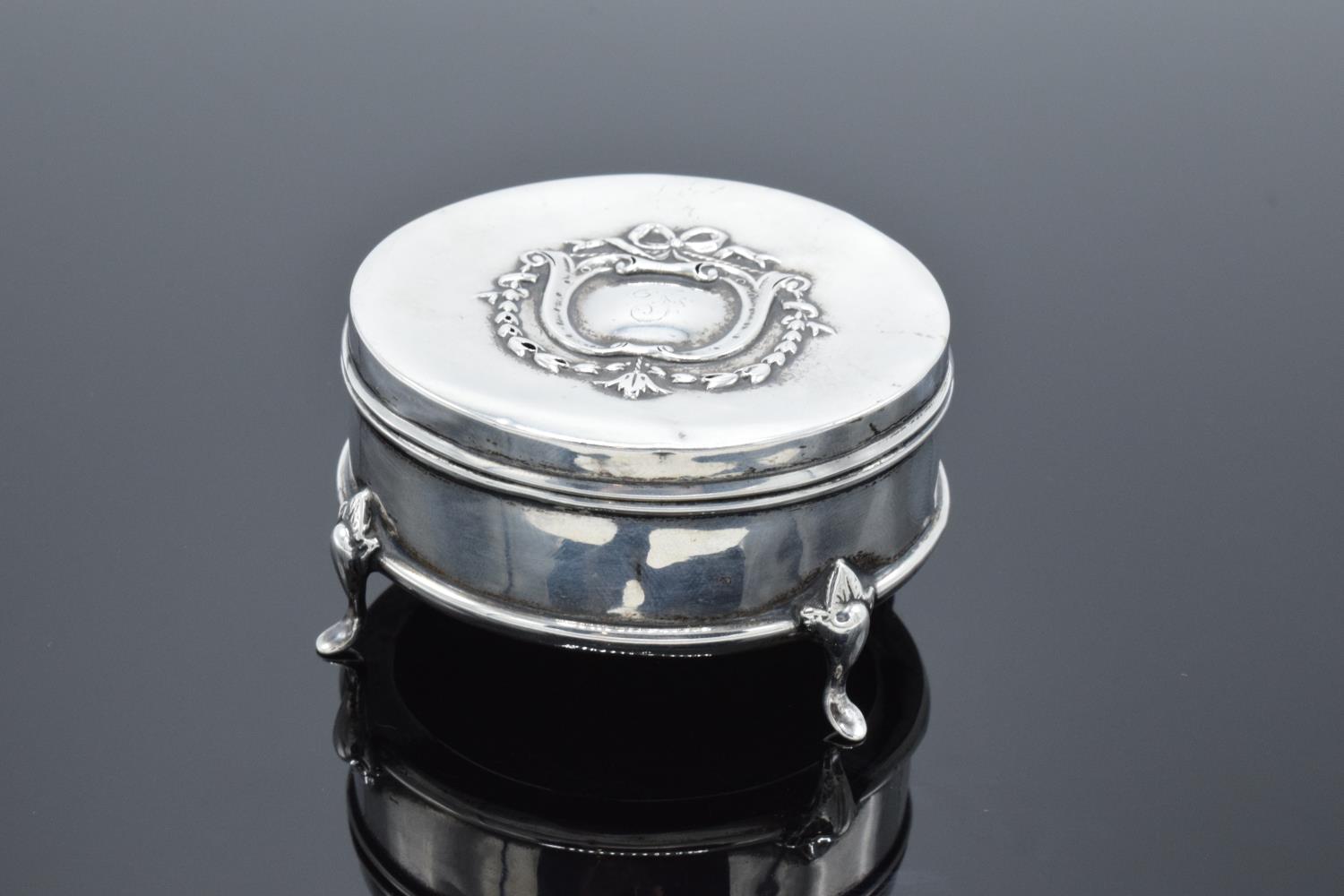 A velvet-lined silver trinket box raised on 4 legs. Birmingham 1910. Gross weight 53.8 grams. Some