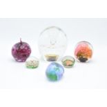 A good collection of glass paperweights to include an apple by Kerry Glass, a large example and 4