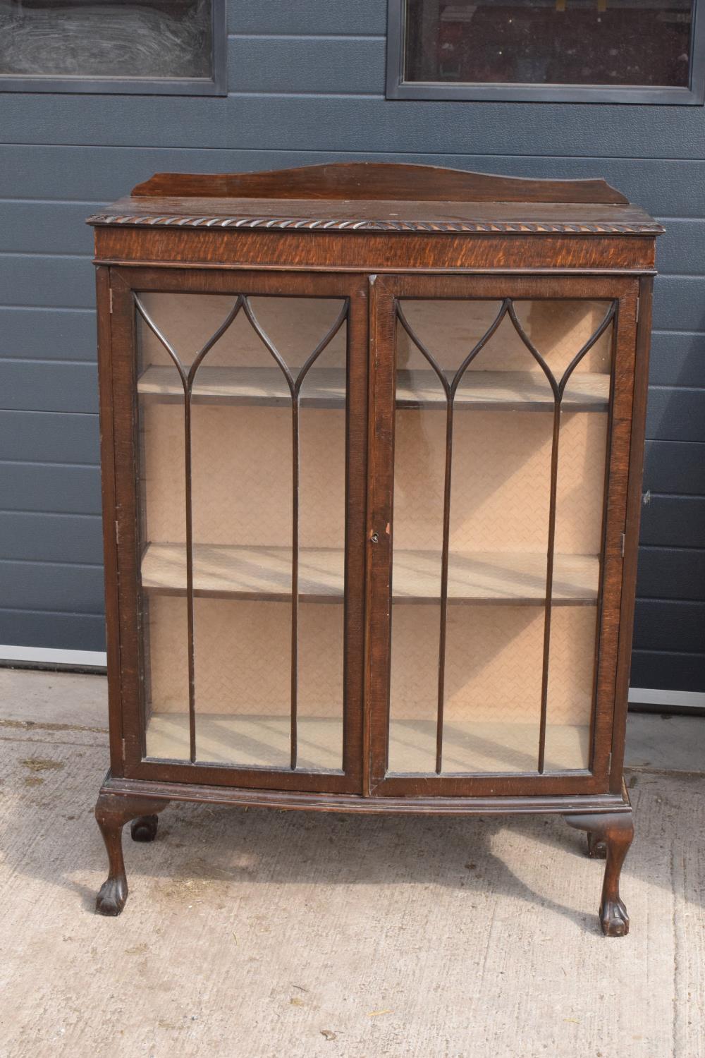 1930s glass display cabinet on ball and claw with carved decoration. . Age related wear and tear.