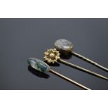 A trio of vintage stick pins to include 2 moss agate examples. With an associated box.