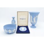 A collection of blue Wedgwood Jasperware to include a large vase, a bowl, a bud vase and a cameo for