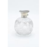 A silver and glass scent bottle with a tortoiseshell style top. Hallmarks are rubbed. Crack to the