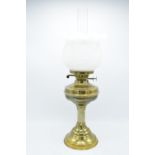 A large Edwardian brass oil lamp complete with an associated funnel and shade. In good condition.