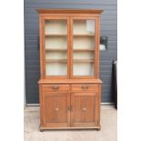 Edwardian/ 20th century golden oak book case with glass doors. In good condition with age related
