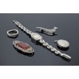 A collection of silver and silver-coloured items to include brooches, a ring and a stainless steel