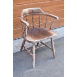 A reproduction wooden captains chair. 76cm tall. In good sturdy condition with some marks, water