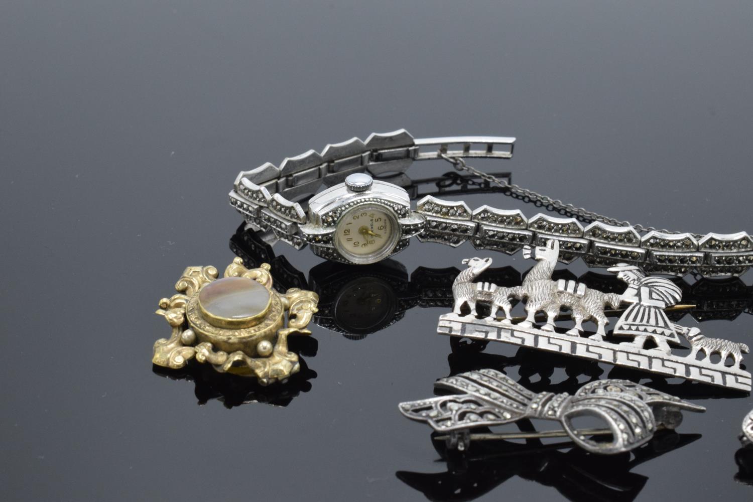 A collection of items to include silver and marcasite brooches, a marcasite wrist watch and a - Image 3 of 3