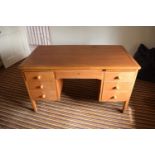 A mid 20th century golden oak desk with draws either side. In good functional condition with age