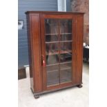 Large Victorian mahogany bookcase on carved feet with foldout sides and a glass panelled door. 3