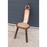 20th century wooden chair with three legs upholstered with cows hair style fabric. Unusual piece