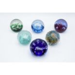 A collection of Caithness paperweights to include Moonflower, Cauldron, Moonflower, Millennium,
