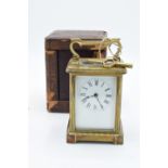 19th century brass carriage clock with an enamel face and a single train movement in a leather