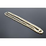 A set of two-string cultured pearls with a 9ct (stamped) clasp set with diamonds.