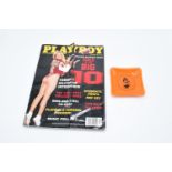 A Playboy glass ashtray together with a magazine from October 1997. Small chip to the ashtray.
