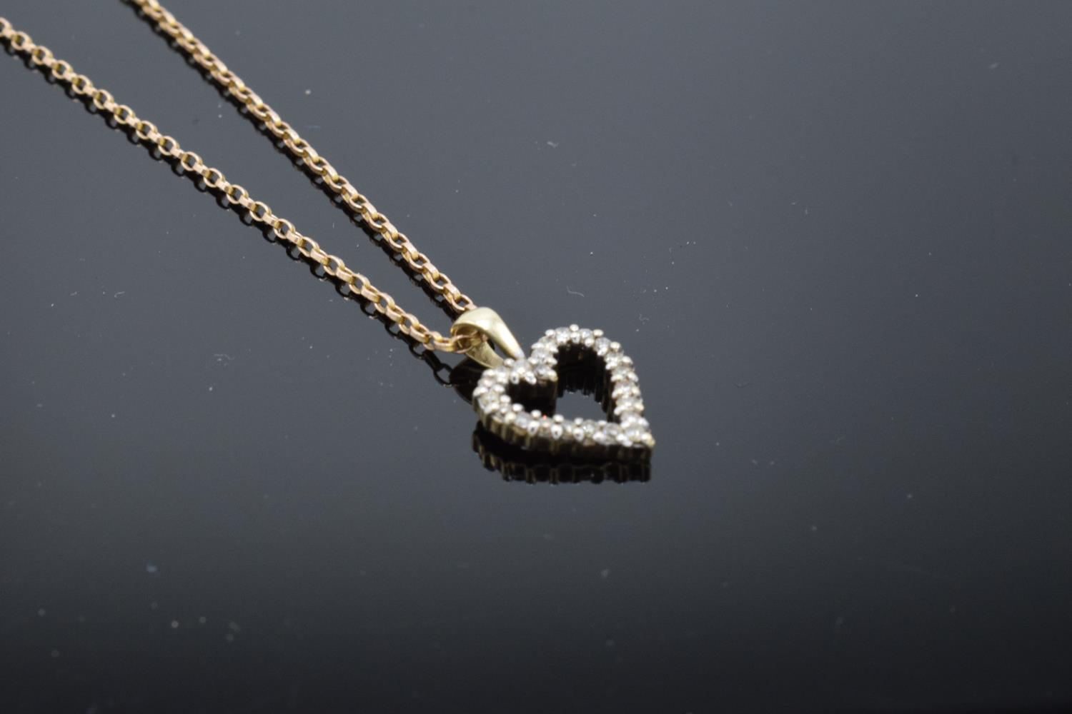 A 9ct gold chain together with a 9ct gold heart-shaped pendant with semi-precious stones, gross