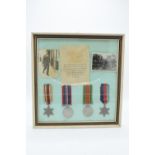 A framed collection of militaria to include photos of soldiers, a message from the Under-Secretary