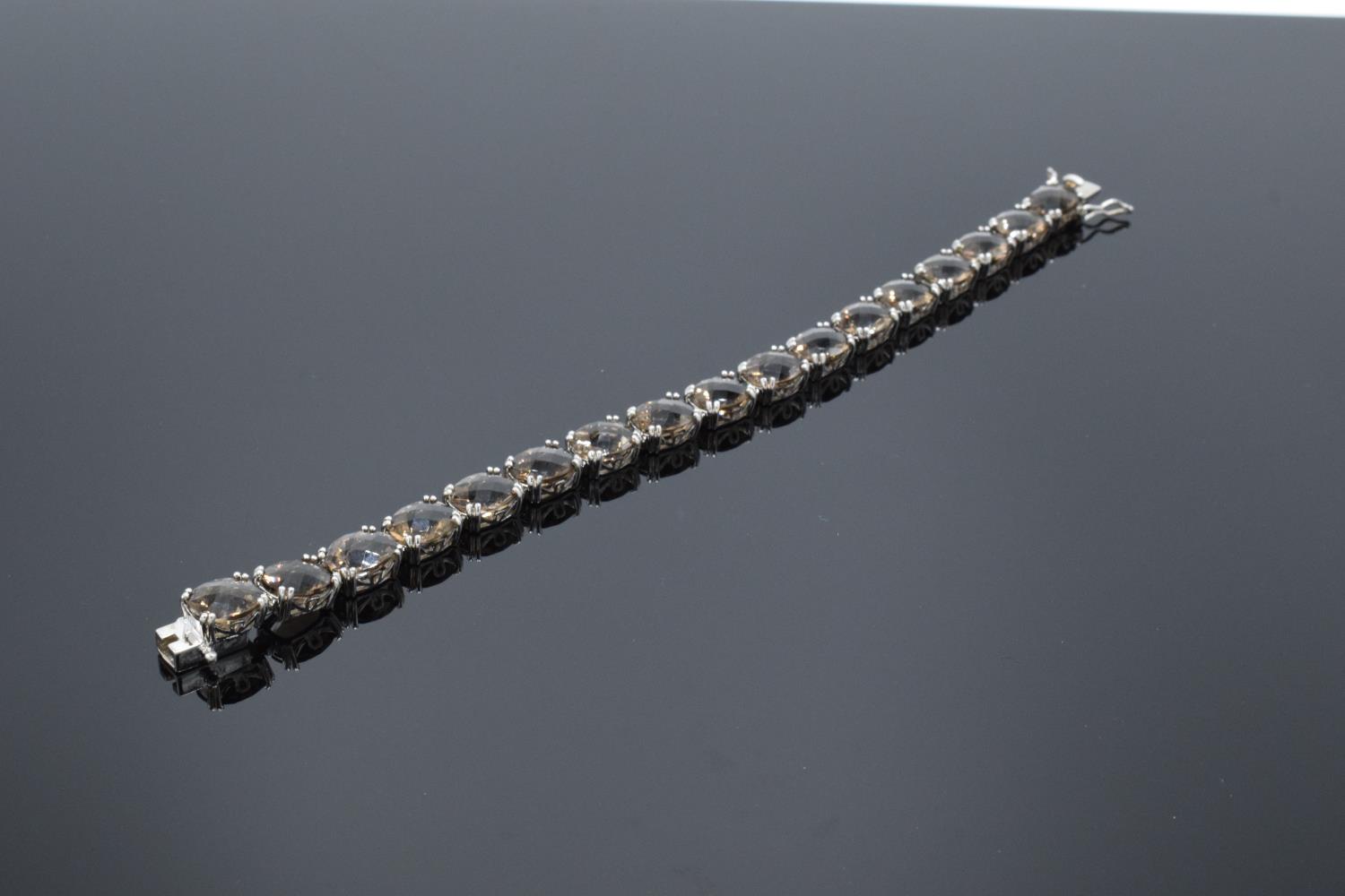 A silver ladies bracelet set with smoky quartz stones, 19.5cm in length. Hallmarked 925 for