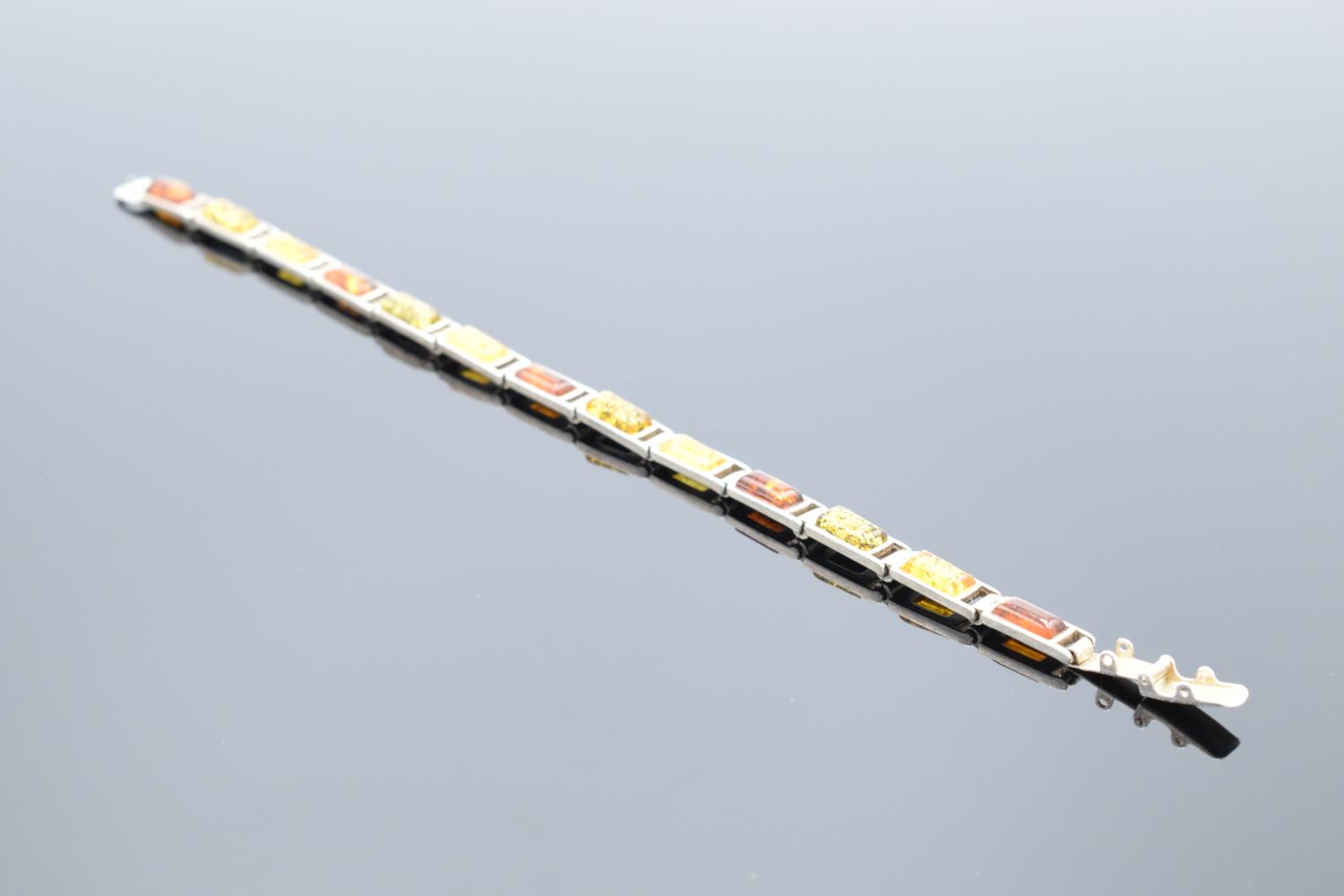 A silver ladies bracelet set with different shades of amber, 18cm in length. 9.8 grams gross weight. - Image 2 of 4