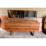 A 1960s G-Plan style teak veneer mirror backed sideboard