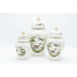 A trio of graduated biscuit barrels/ ginger jars by Sadler with a birds and foliage scene with a
