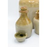 A collection of stoneware items to include a chicken water feeder, a jar, a jug, a decanter with