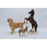 A collection of pottery to include a Beswick donkey foal 2110, a Hertwig rearing horse and an