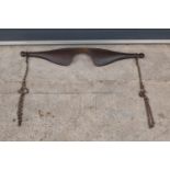 An antique farmer's wooden yoke complete with chains and hooks. 90cm wide. In good functional