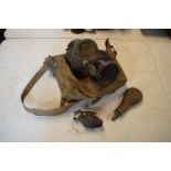 A mixed collection of militaria items to include a 1939 gas mask in bag, a gun powder flash and a