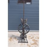 A late 19th century wooden spinning wheel 153cm tall. In good condition with signs of wear and use