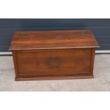 A 1930s wooden blanket box with ornate central design. 91 x 44 x 43cm tall.