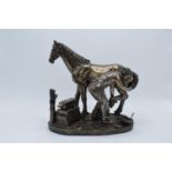 A Crosa bronze-effect resin figure of a Farrier and Horse. 26cm tall. In good condition with no